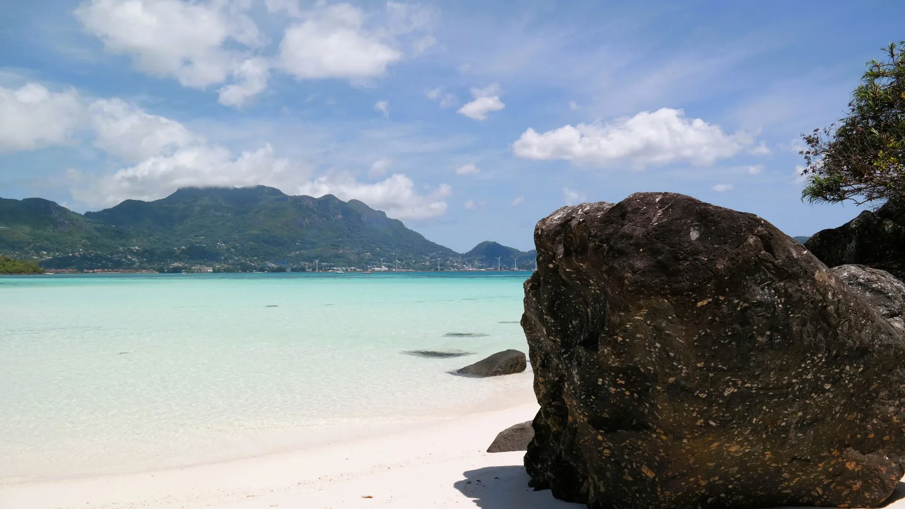 Un grande masso di granito sul bordo di acqua bassa e limpida