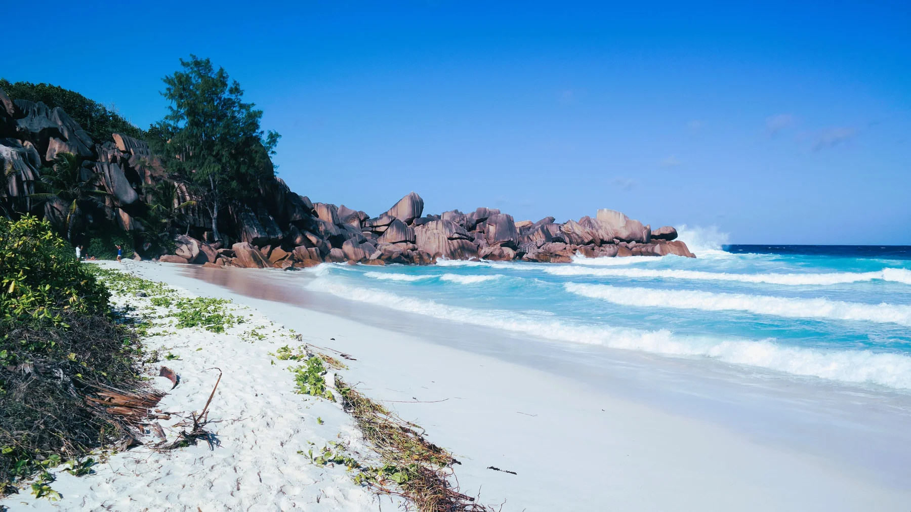 Waves beside coastal rocks in Seychelles